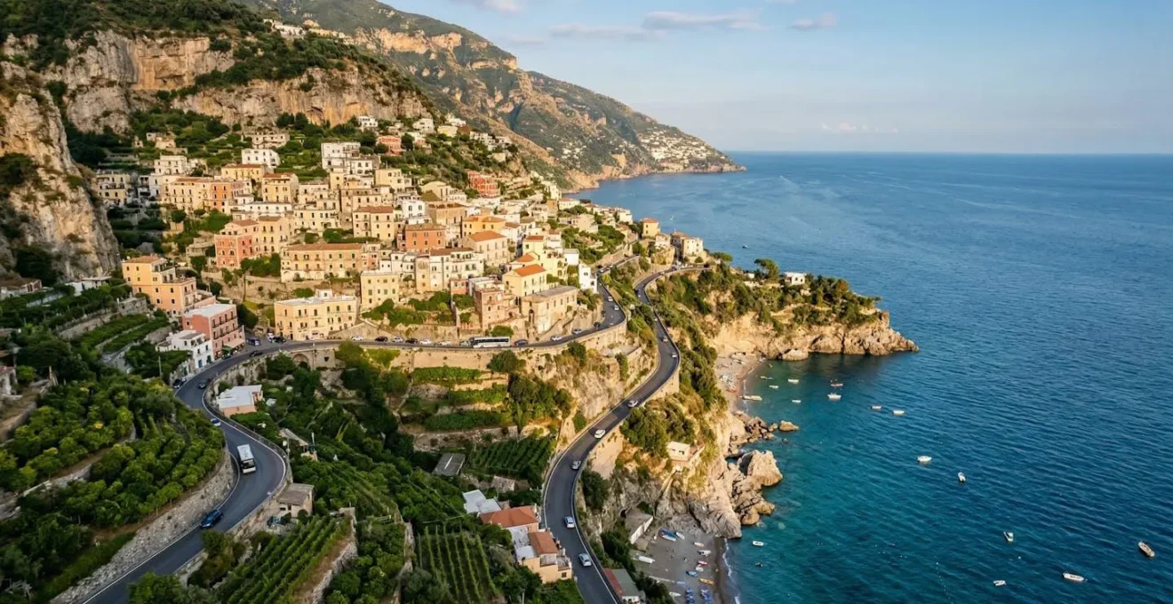 Scenic view of pastel-colored houses cascading down cliffs to turquoise Mediterranean waters